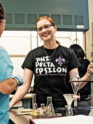 Chemistry major Carmela Riposo leads an Organic Chemistry lab.