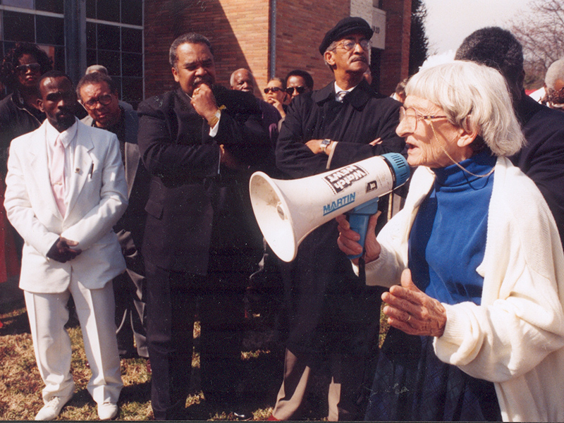 Anne Braden speaking to group with megaphone