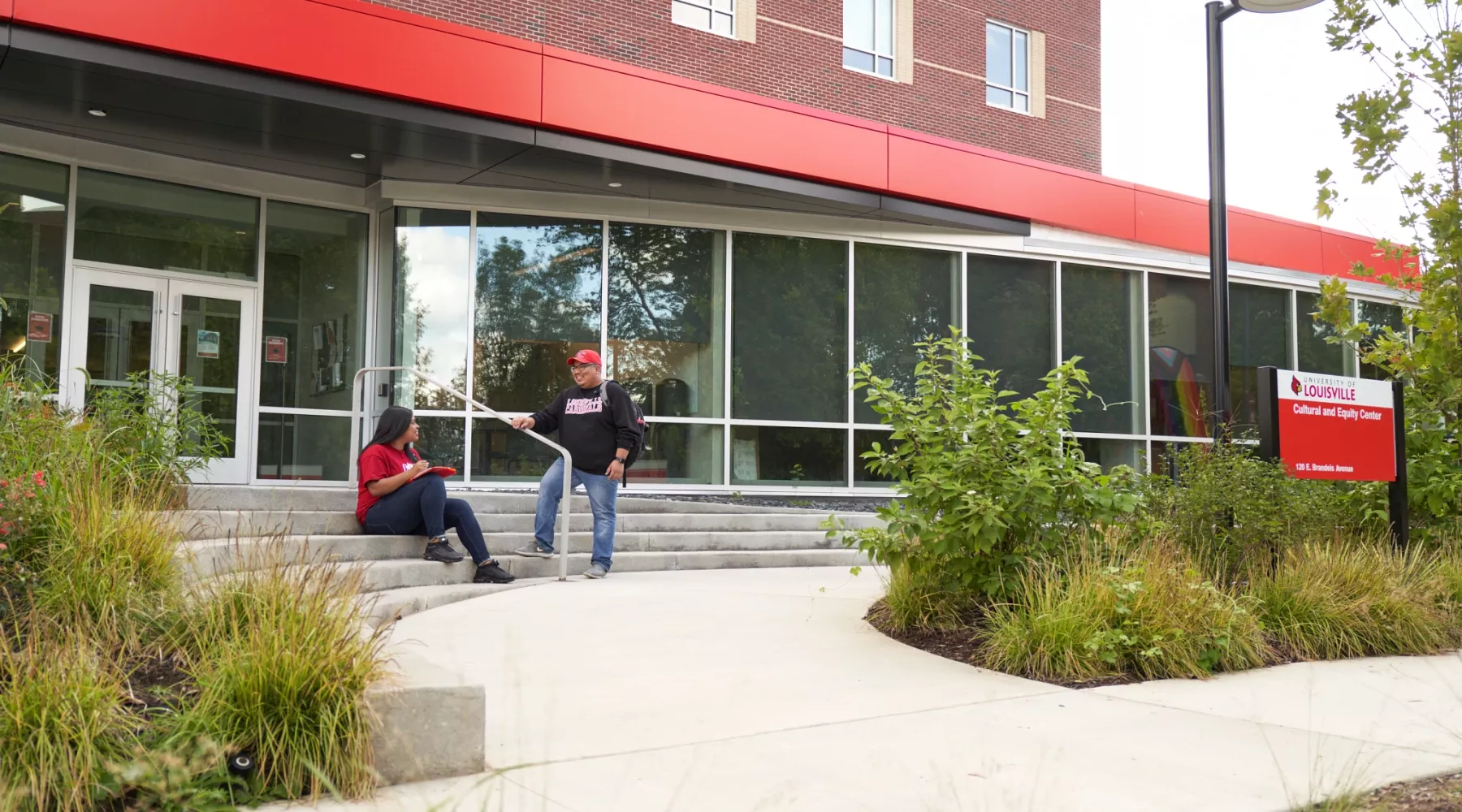 Two students talk outside the Cultural and Equity Center.