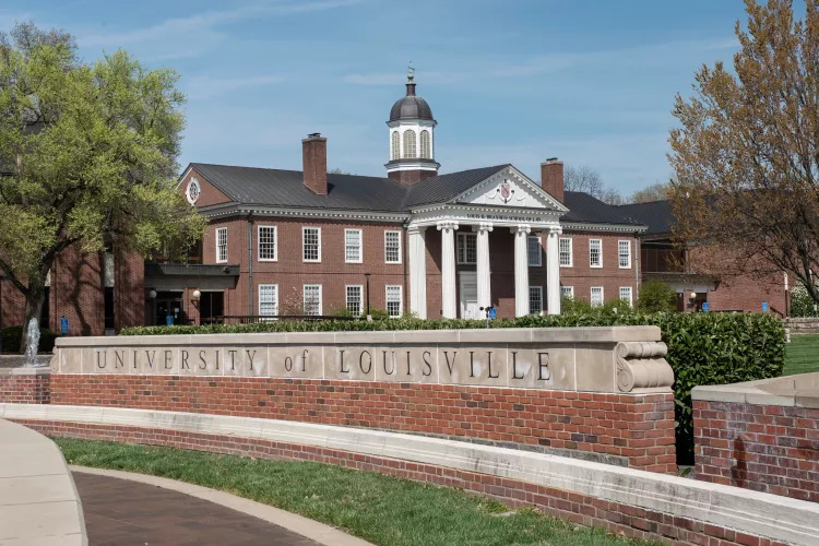 Louis D. Brandeis School of Law building in the background with the main University of Louisville entrance sign on 3rd…