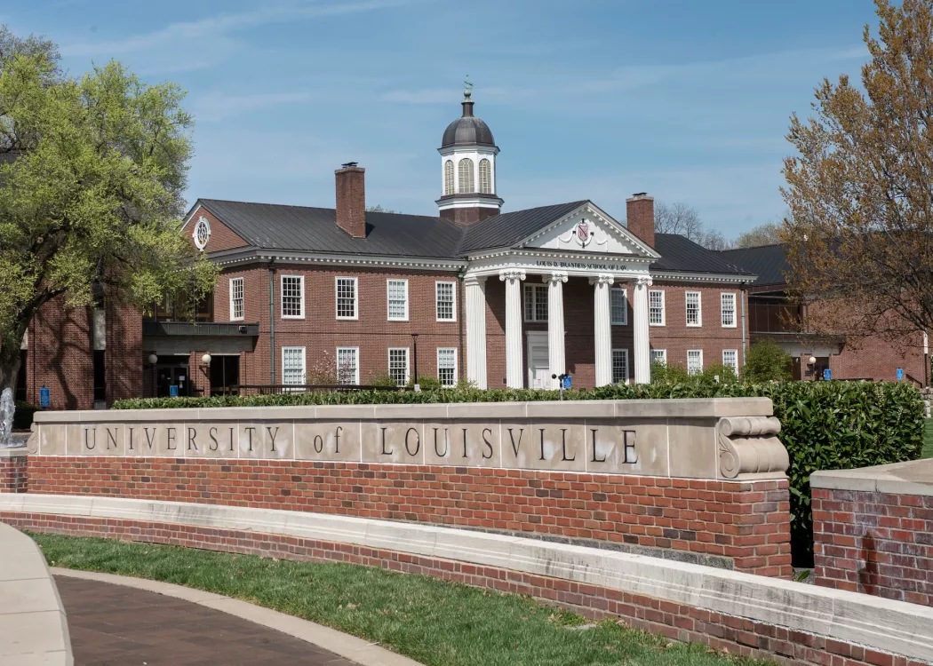Louis D. Brandeis School of Law building in the background with the main University of Louisville entrance sign on 3rd…