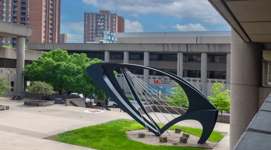 View of the School of Dentistry from Kornhauser Library, with the Ad Astra Sculpture in the foreground