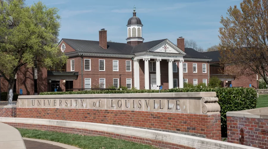 Louis D. Brandeis School of Law building in the background with the main University of Louisville entrance sign on 3rd…