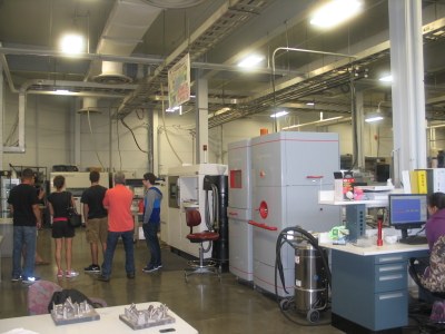 photo of Arcam equipment with tour group in background 