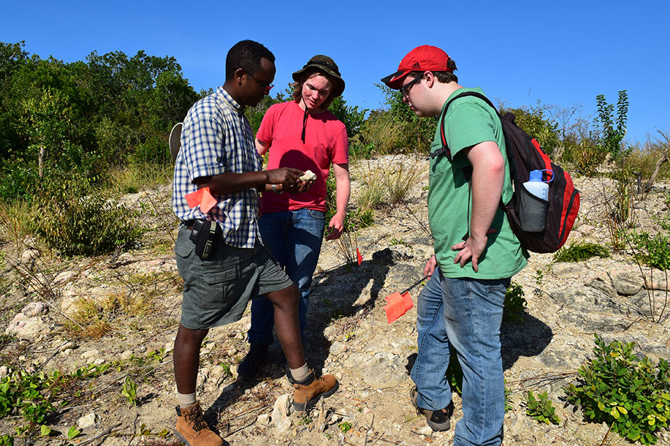 Prof. Beyin showing students a fossil in Tanzania