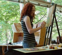 student artist painting on canvas