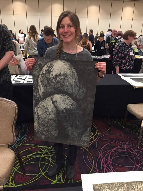 Professor Rachel Singel holding one of her artworks at the SGC International Conference