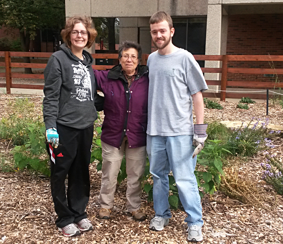 Dr. Margaret Carreiro (middle) happy to have help weeding and watering the garden fromgraduate students Lindsay Nason (left) and Matt Reid (right).