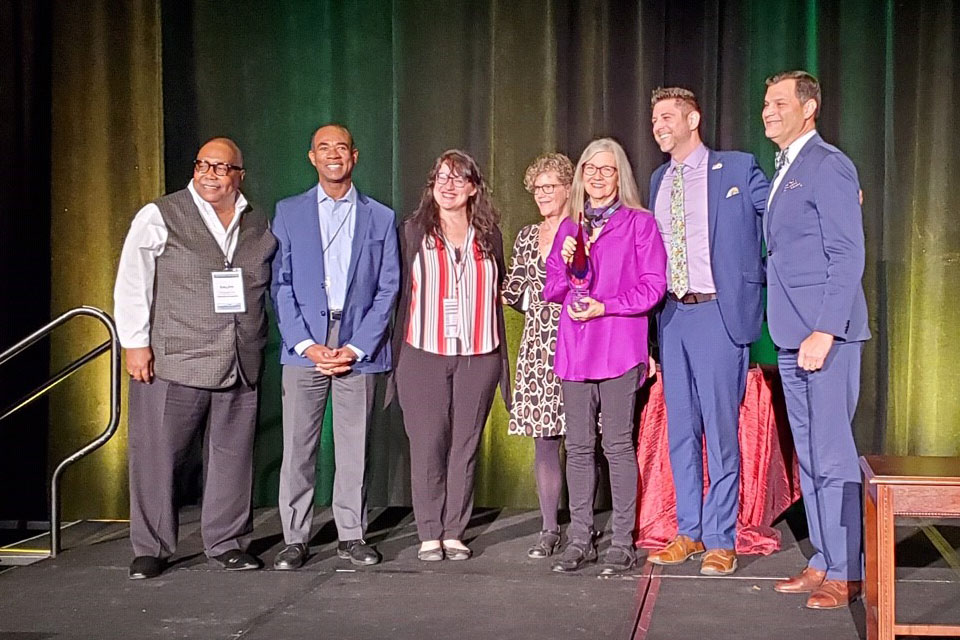 Cate Fosl and other project members receiving the W. K. Kellogg Foundation CommunityEngagement Scholarship Award in 2019