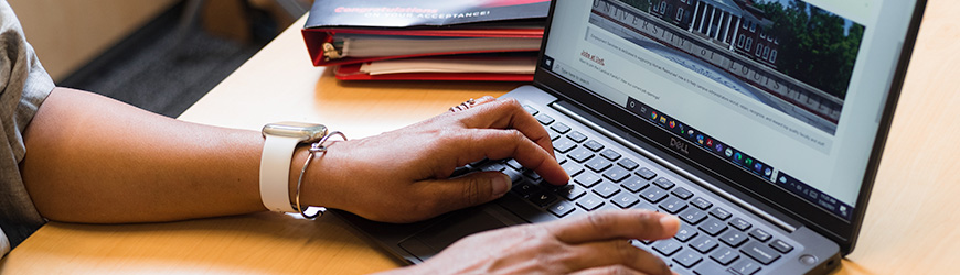 Photo of man typing on laptop