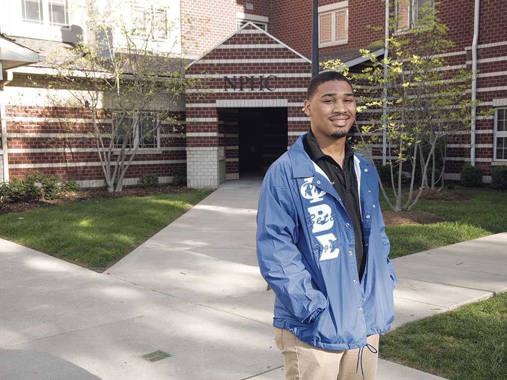 A student outside his fraternity house
