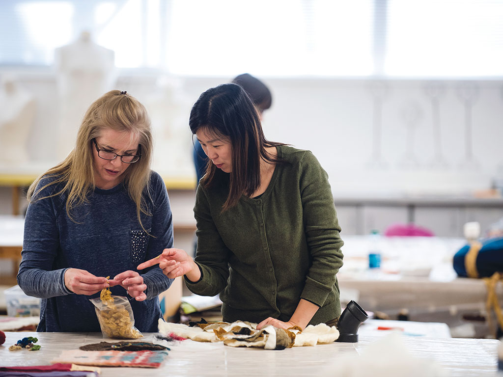 Fiber arts teacher instructing a student