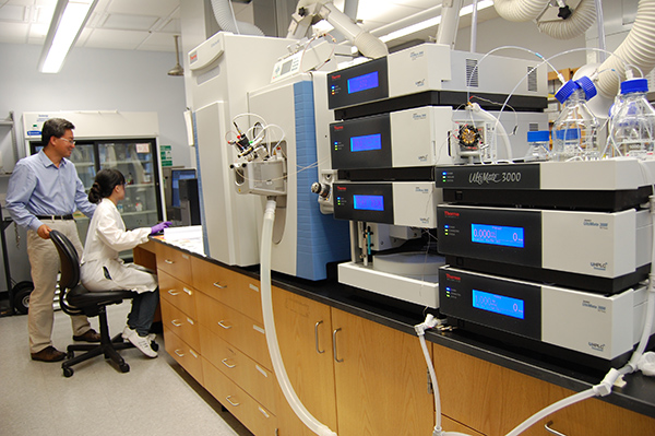 Student and professor with mass spectrometer