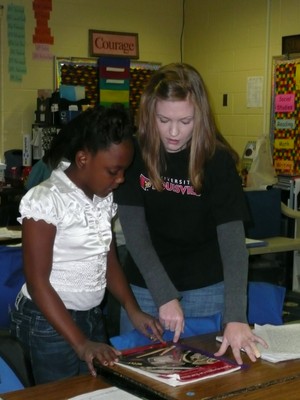 UofL Student teacher assists elementary student