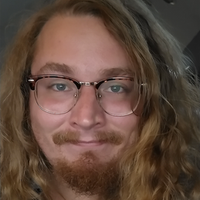 Man with long blonde hair, goatee, and glasses