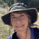 Emily Ronay Johnston, a White European American cis woman with green sunhat Emily Rónay Johnston