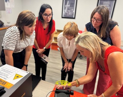 Erica Gaunt from Ultradent shows some of the features of the EVO laser unit to UofL dental hygiene faculty and staff.