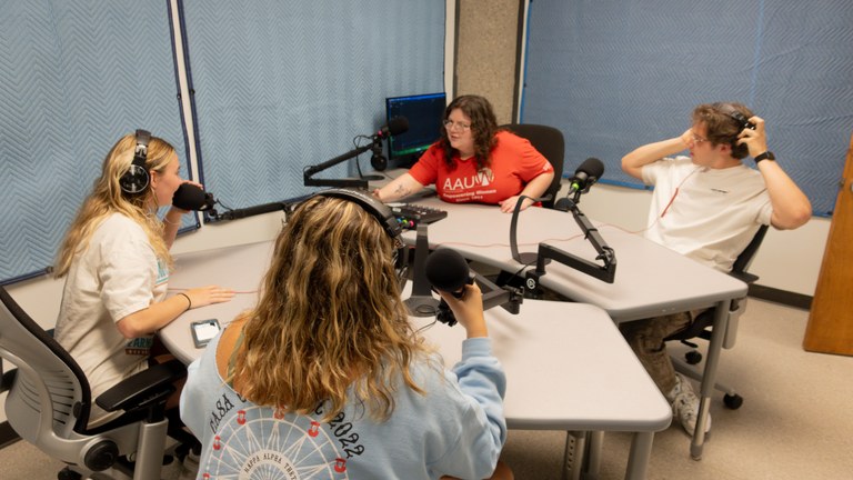 four students in the Podcast Studio