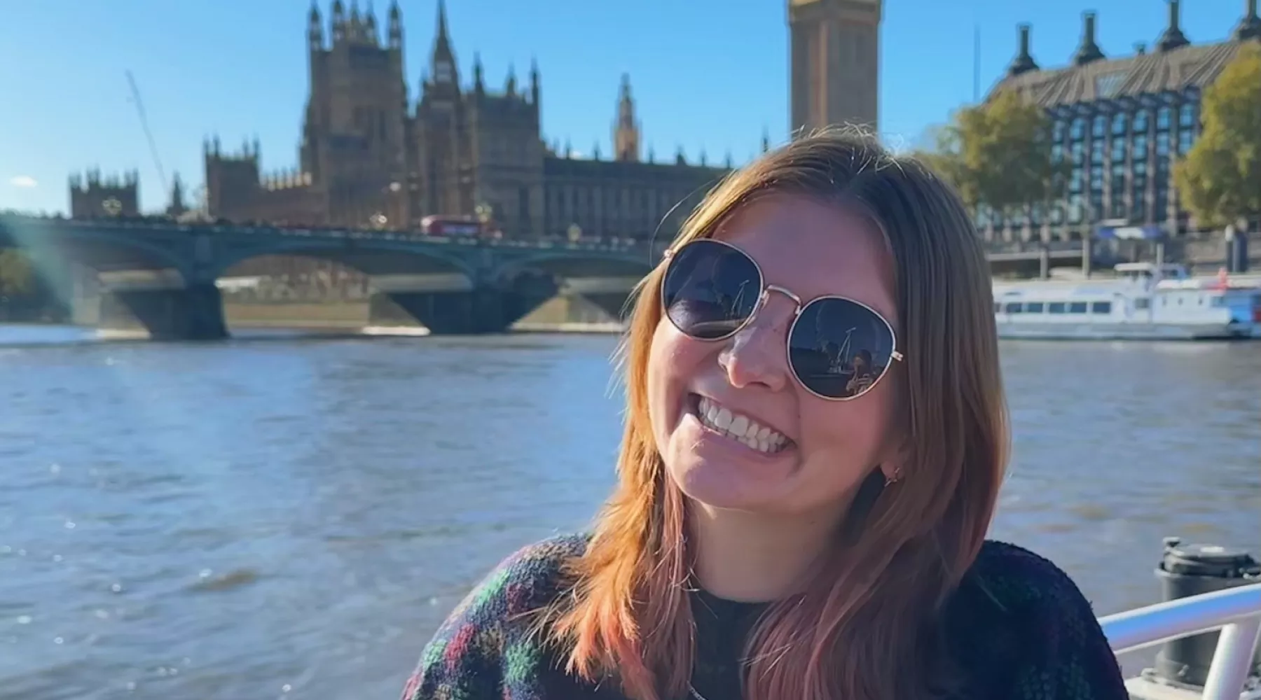 UofL students smiles with Big Ben in the background in London, UK.