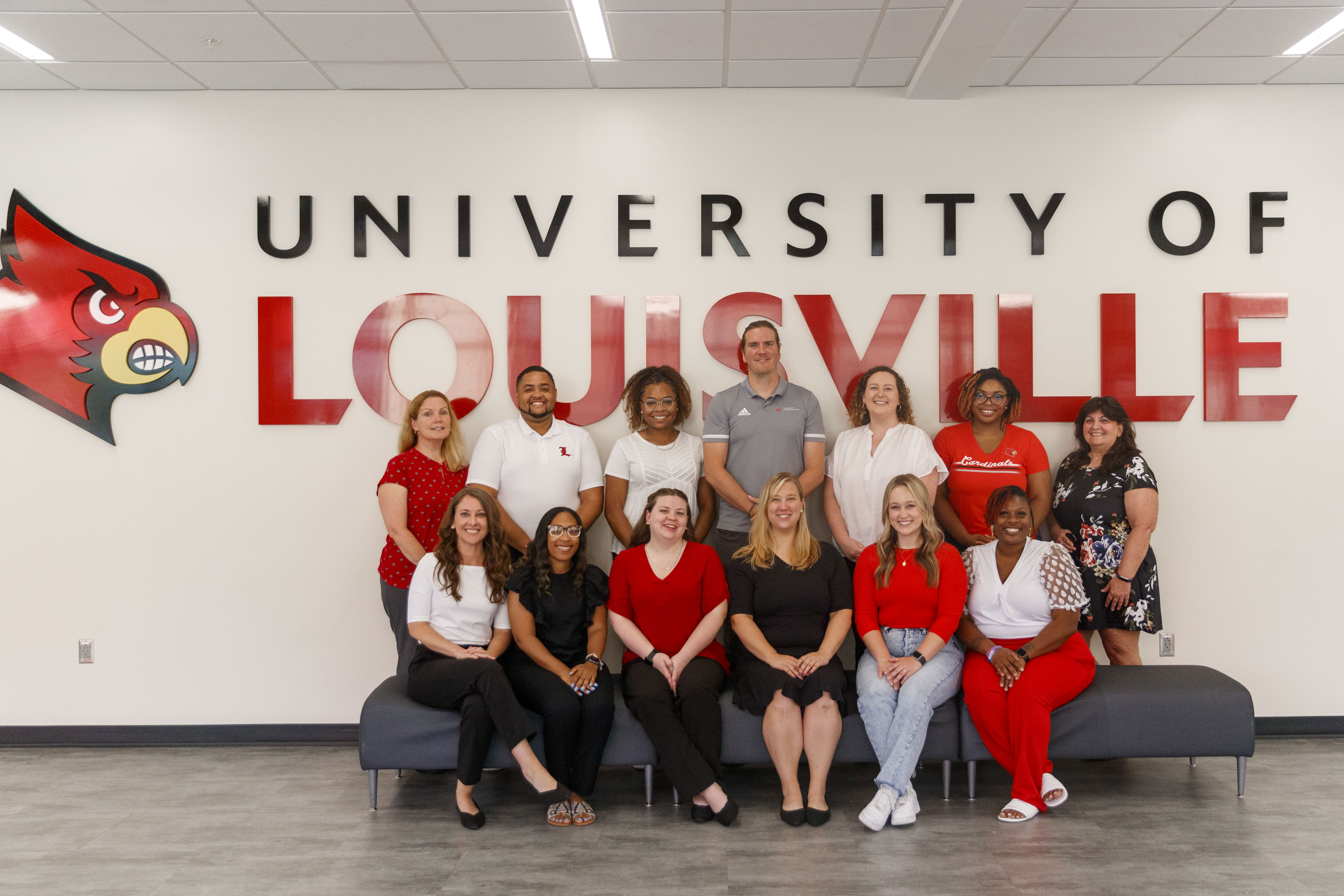 group picture of the Student Involvement staff posing in front of a University of Louisville sign