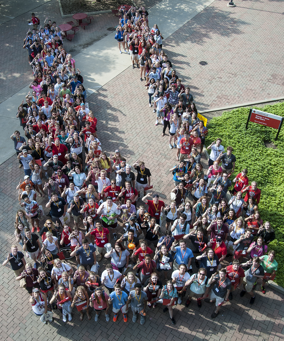 UofL Students arranged in a large U shape, each raising the L