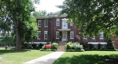 Front facing view of Oppenheimer hall on a summer day. 