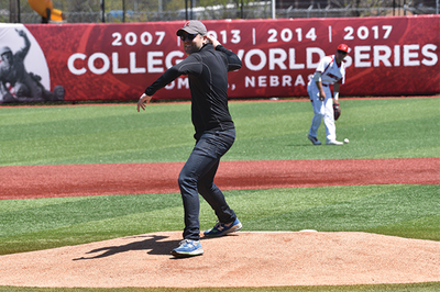 Professor Justin Walker throws out the first pitch.