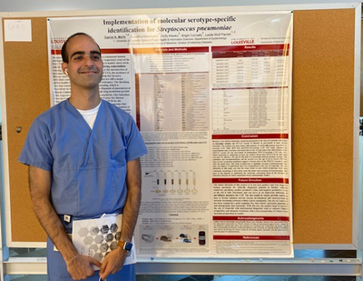 Danial Malik, with his poster at Research Louisville