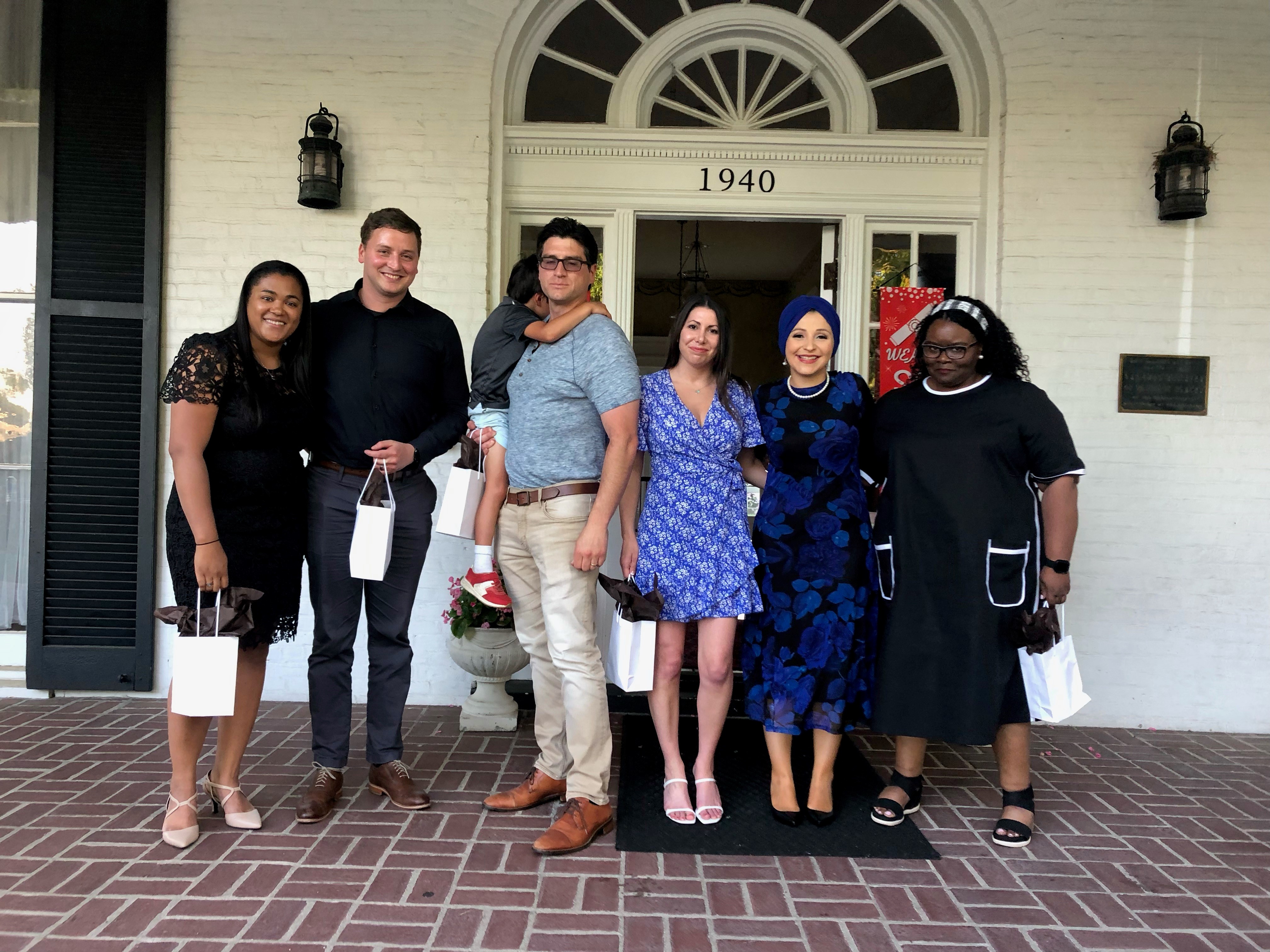 Residents leaving the UL psychiatry residency program. They are standing on the front porch of the Nunnlea House, where the resident graduation took place.