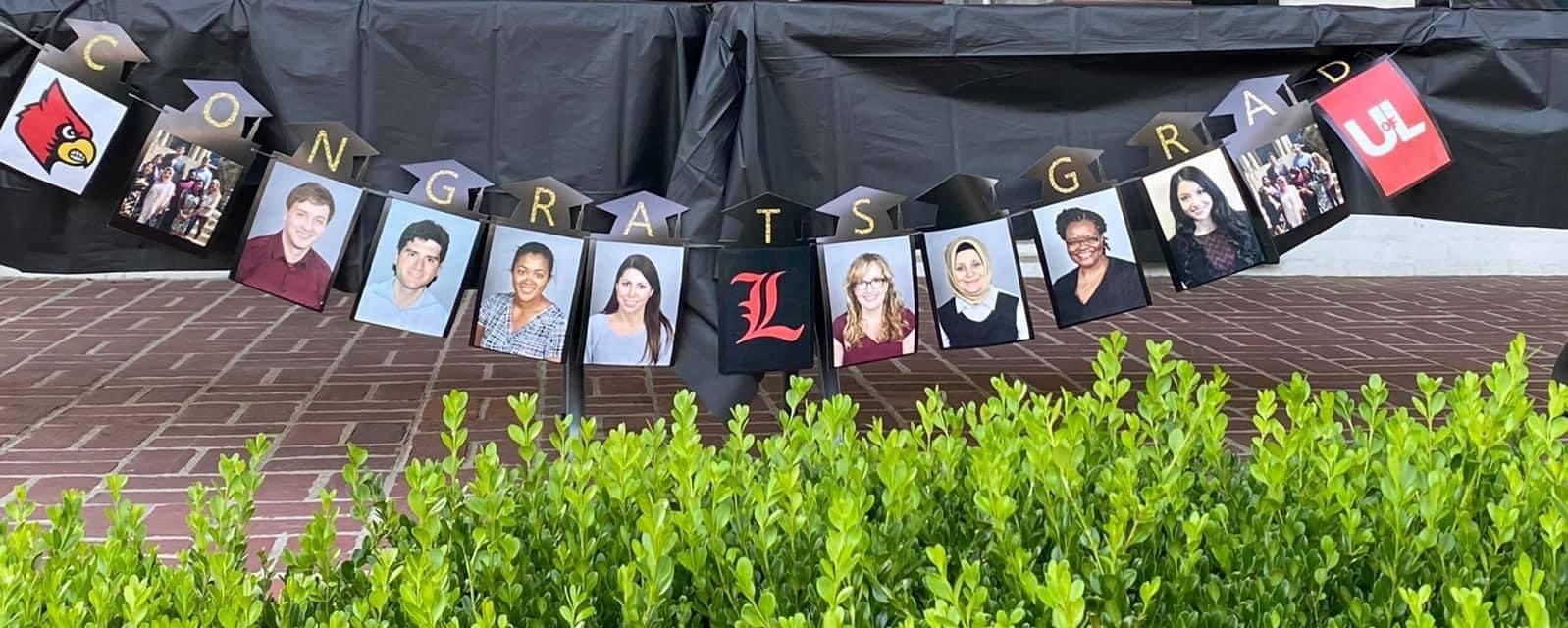 congrats grad banner with pictures of all graduating or exiting residents.