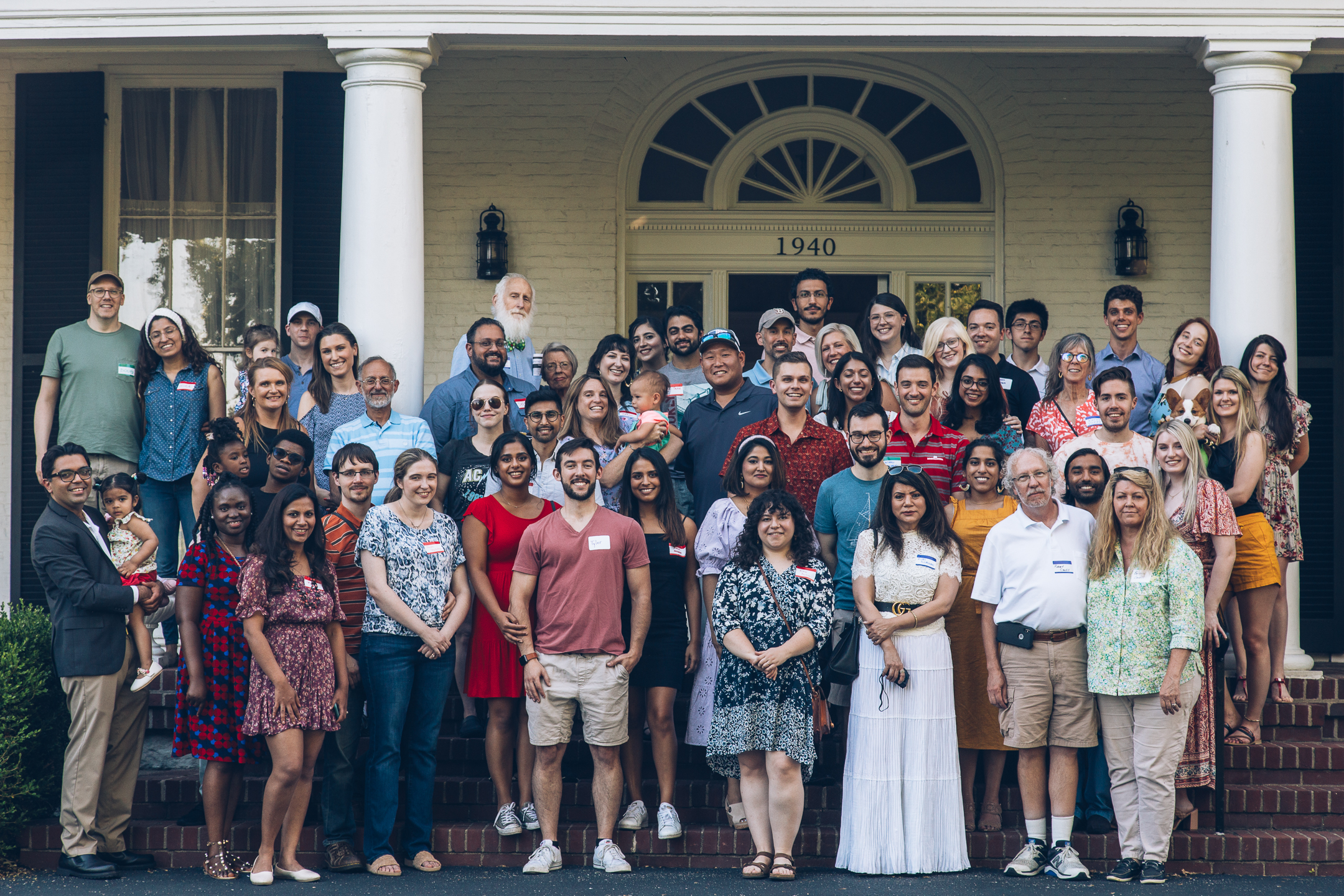 Department of Psychiatry faculty, residents and families (including dogs!) pose on the step of the Nunnlea House at the annual department picnic.