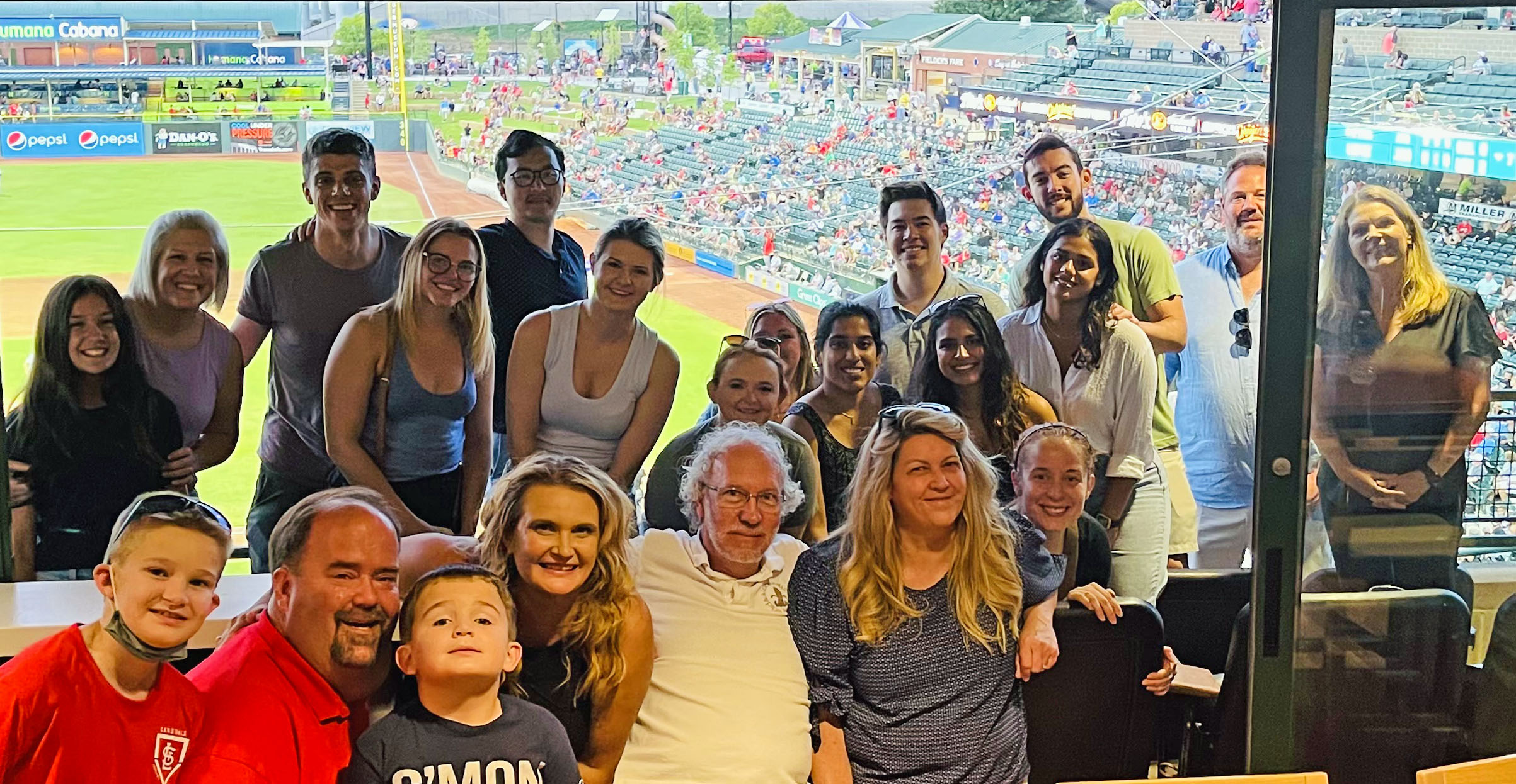 Residents and families at a baseball game. July 2022