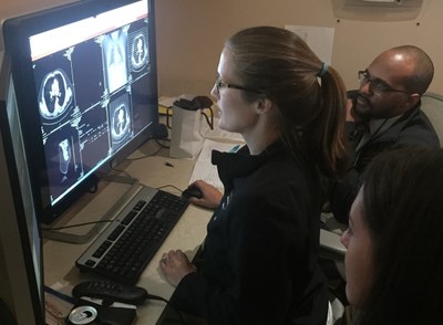 Dr. Brittany Schulz reads out a chest CT with Dr. Raymond McDermott and a rotating 4th-year UofL medical student.
