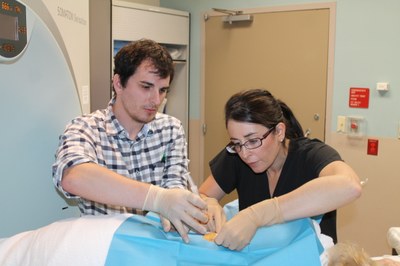 Dr. Justin Broadhead assists Dr. Tracy Van Meter with a lung biopsy.