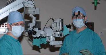 Two surgeons use elaborate equipment
