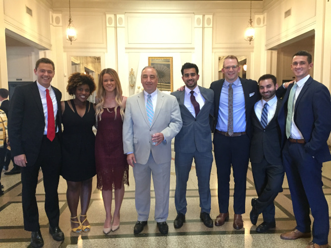 A group of residents and faculty smiling.