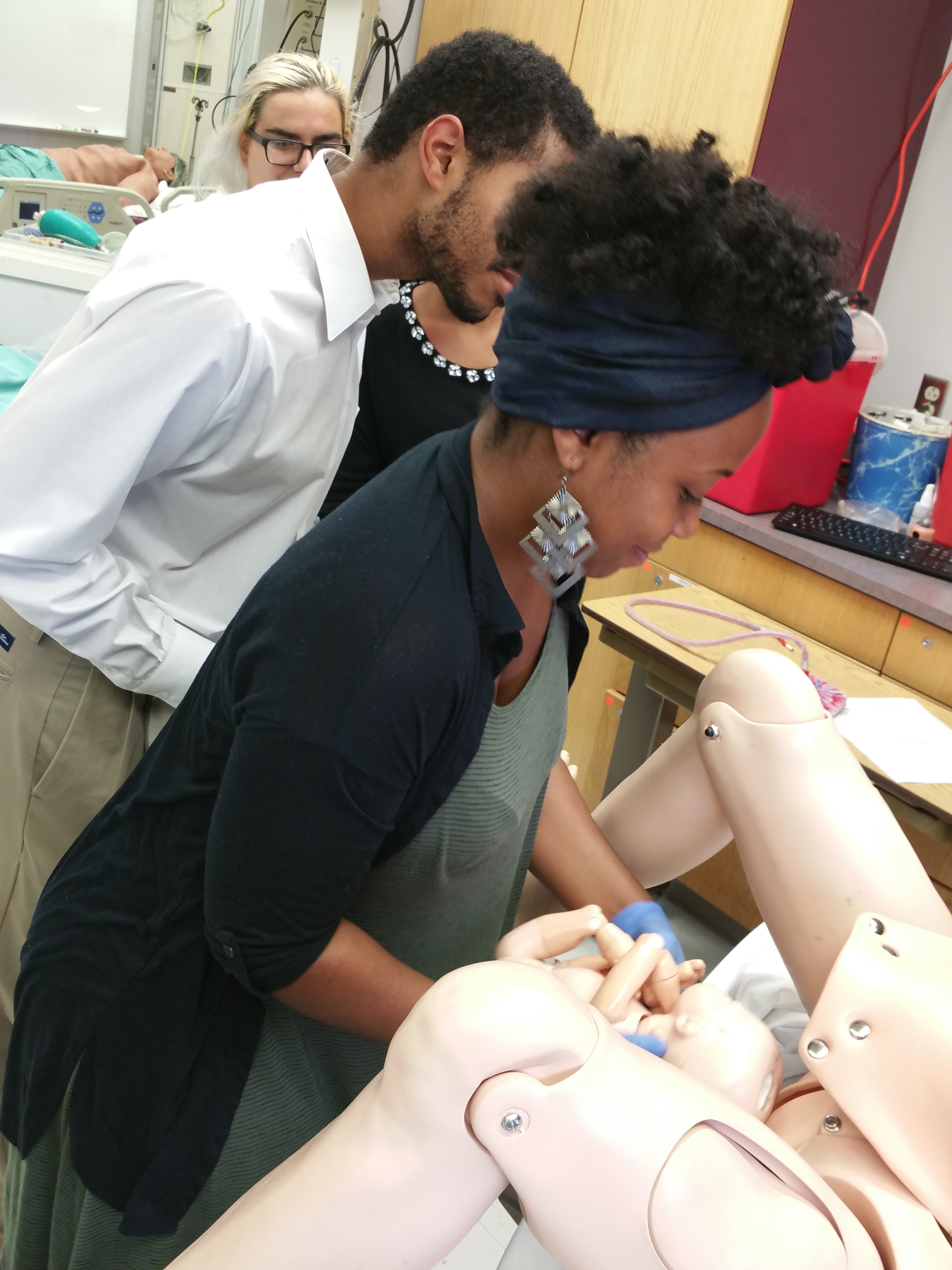 Prematric students delivering a simulation baby