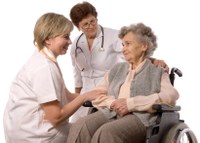 Doctor and nurse with Elderly lady in wheelchair