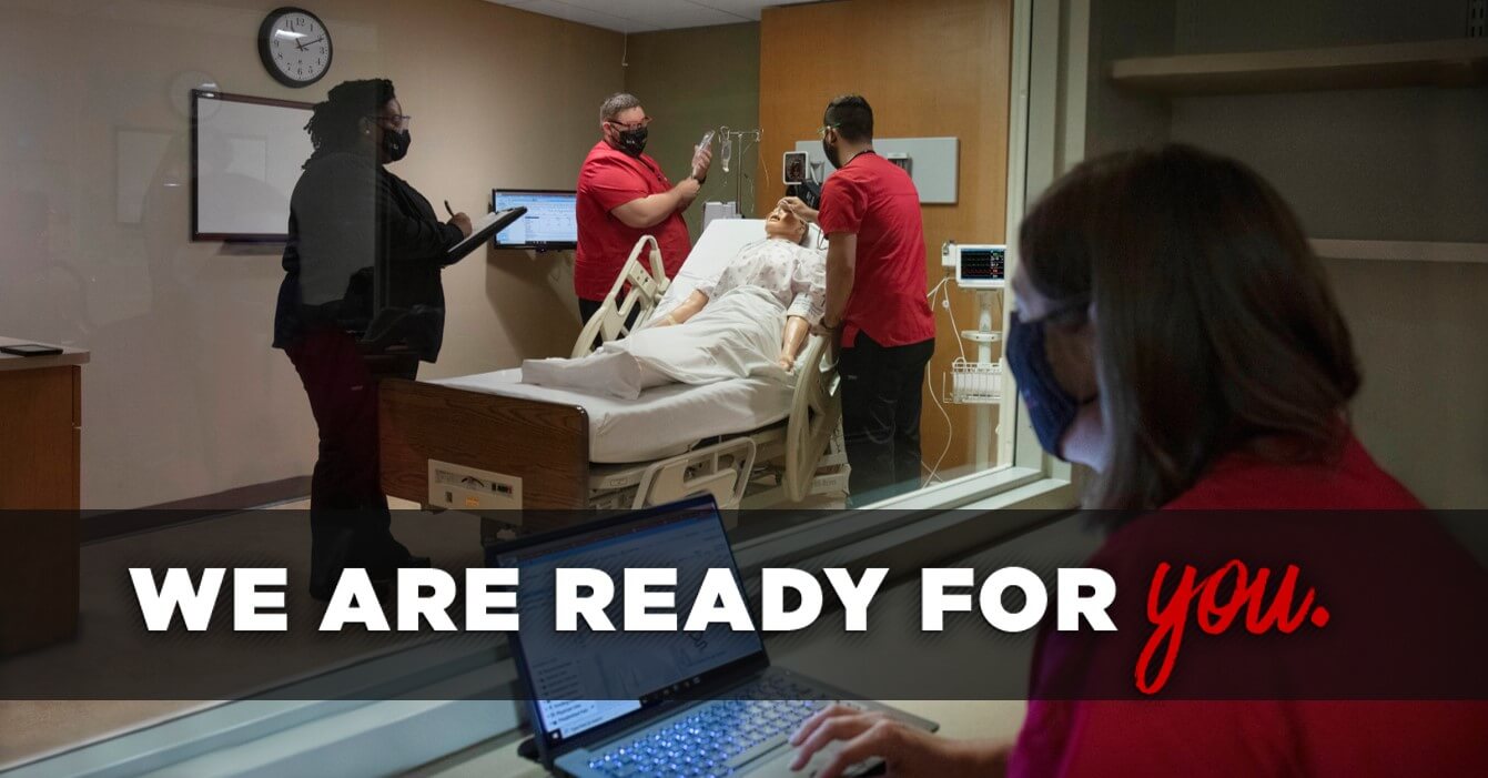 Photo of two nrusing students in a simulation lab with a mannequin overseen by faculty with overlay that reads 'We are ready for you.'