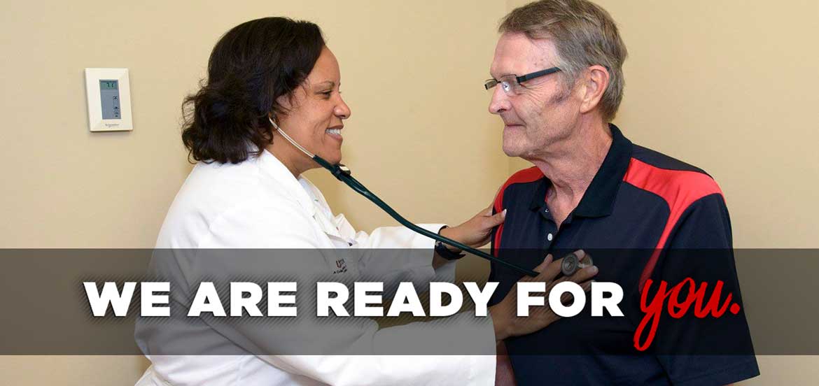 Photo of nurse practitioner faculty using a stethoscope to listen to the heart of a male patient with a photo overlay that reads 'We are ready for you.'