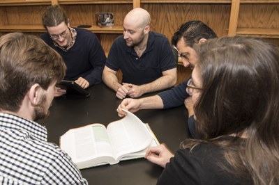 phd students around a table