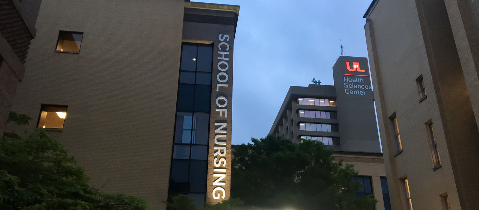 Early morning photo of the School of Nursing entrance with the UofL Health Science Campus Instructional Building in the background.