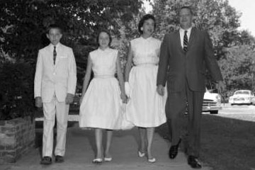 Family walking in an old black and white photo
