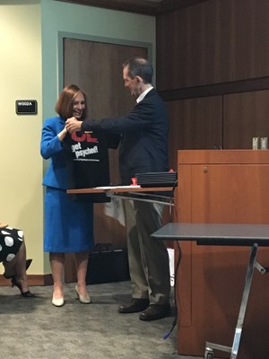 Dr. Salmon presents Connie Herold with a Get Psyched! t-shirt
