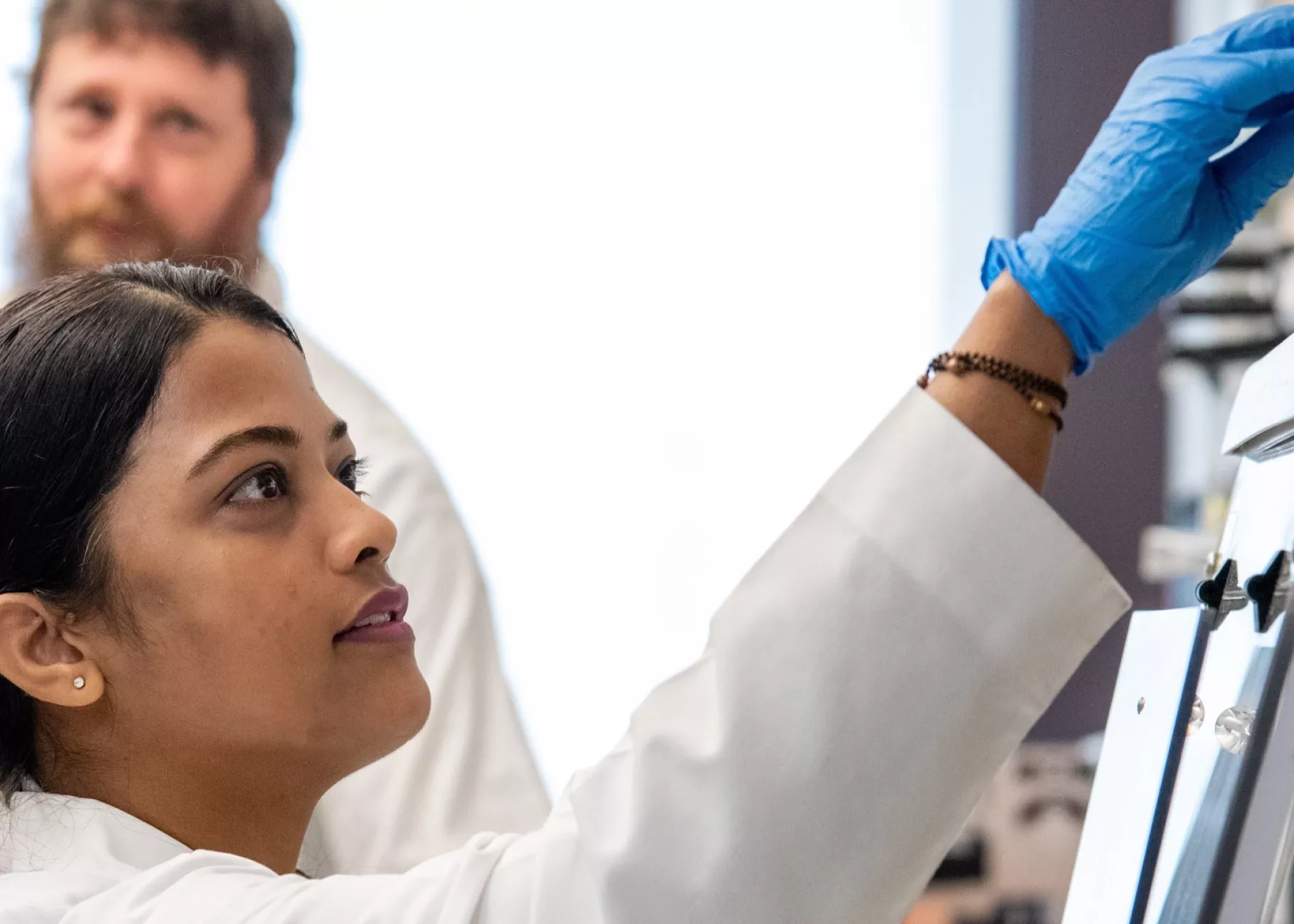 A woman and man in a research setting.