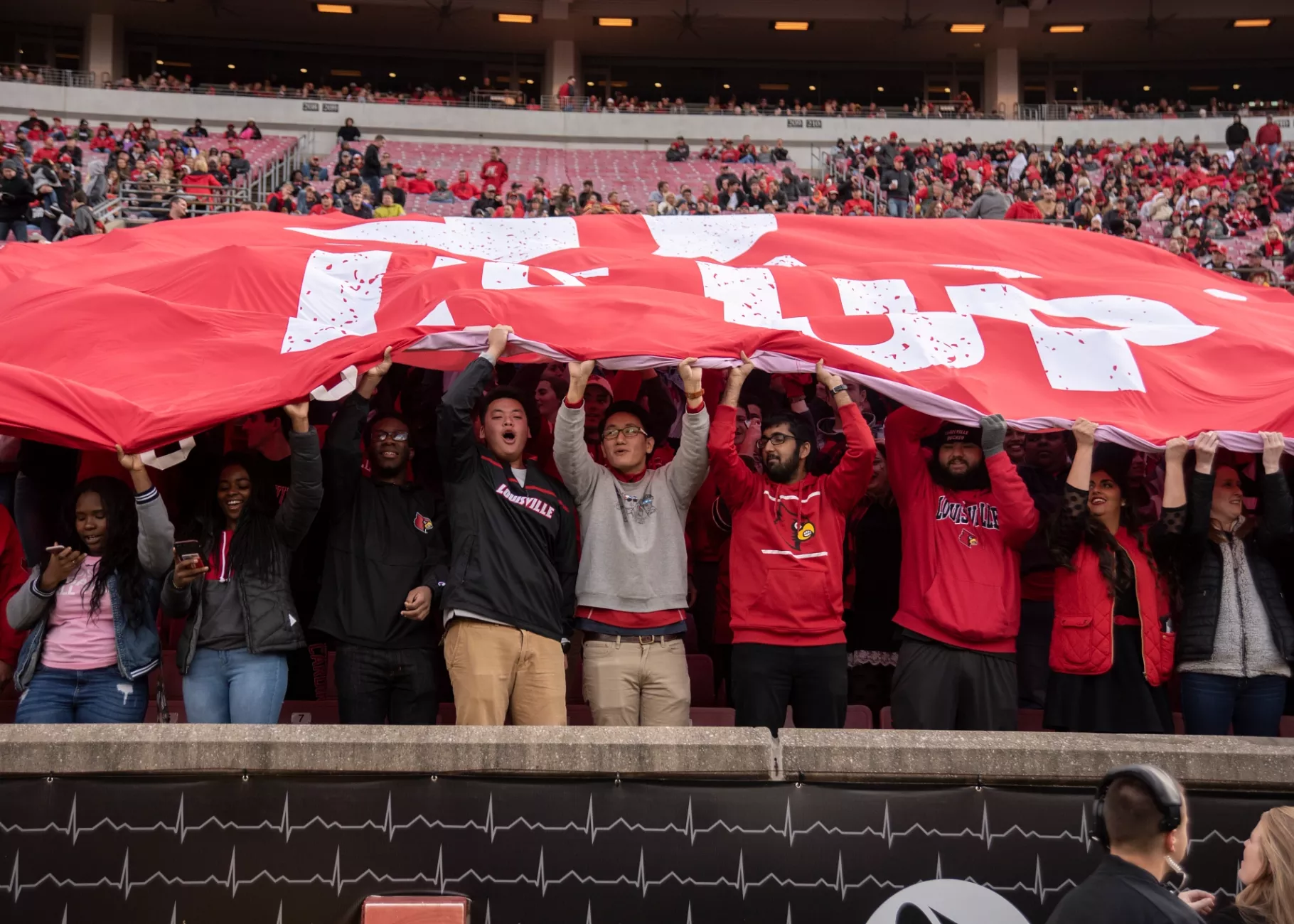 Villains Fan group at a football game holding an L's Up banner