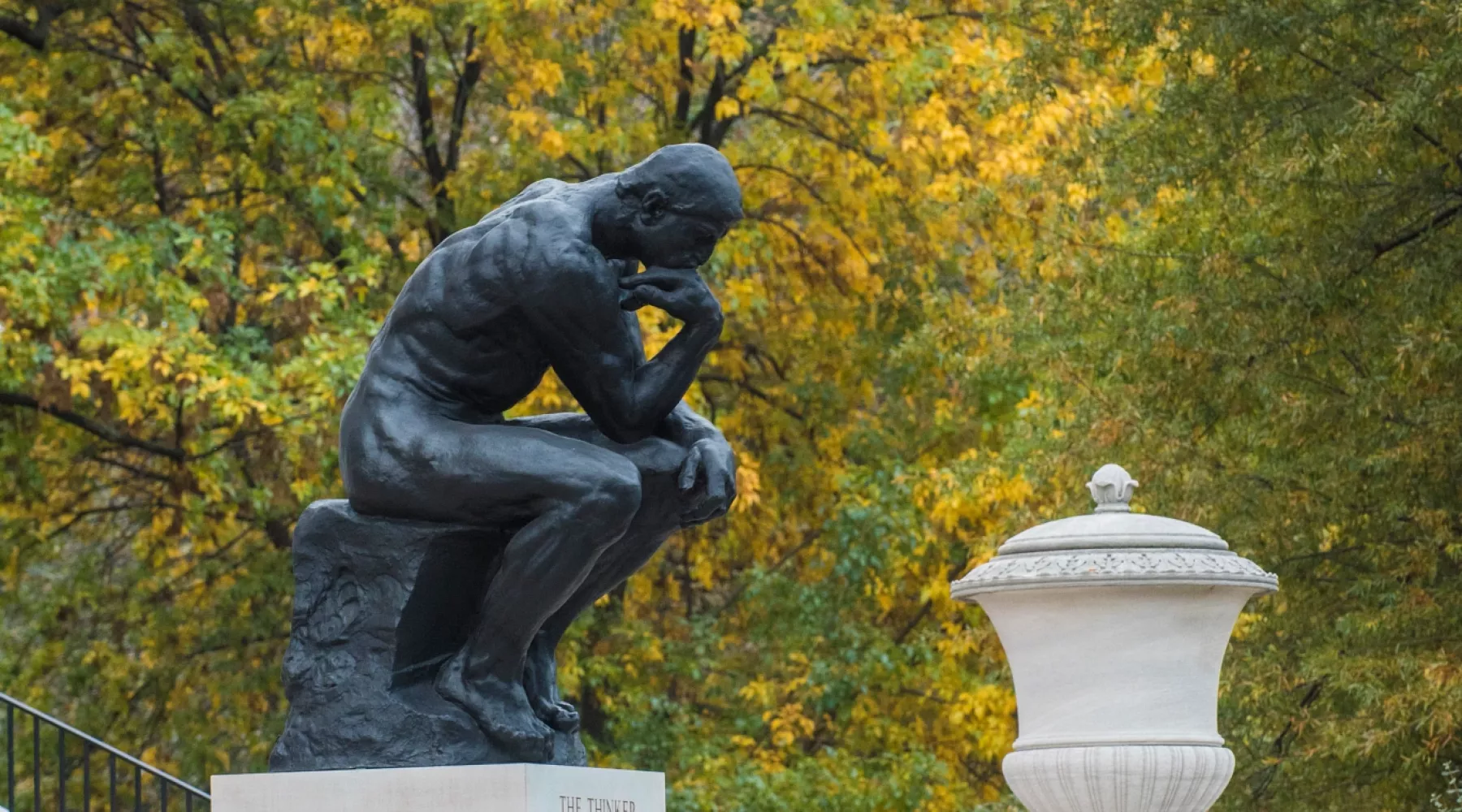 Steps of Grawemeyer Hall and The Thinker against fall trees