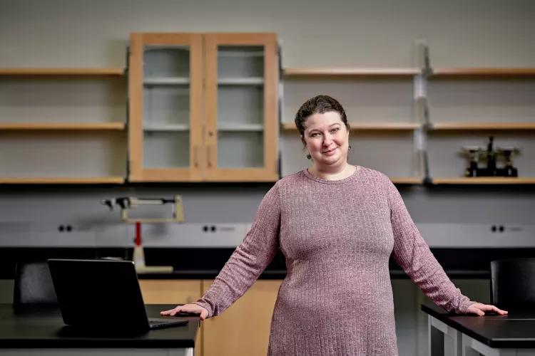 Cheri Levinson with a laptop in a chemistry lab setting