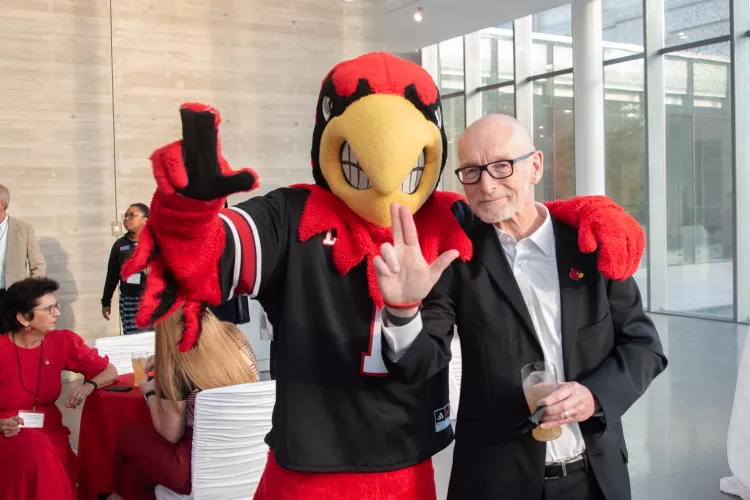 Louie the Cardinal poses with President Bradley