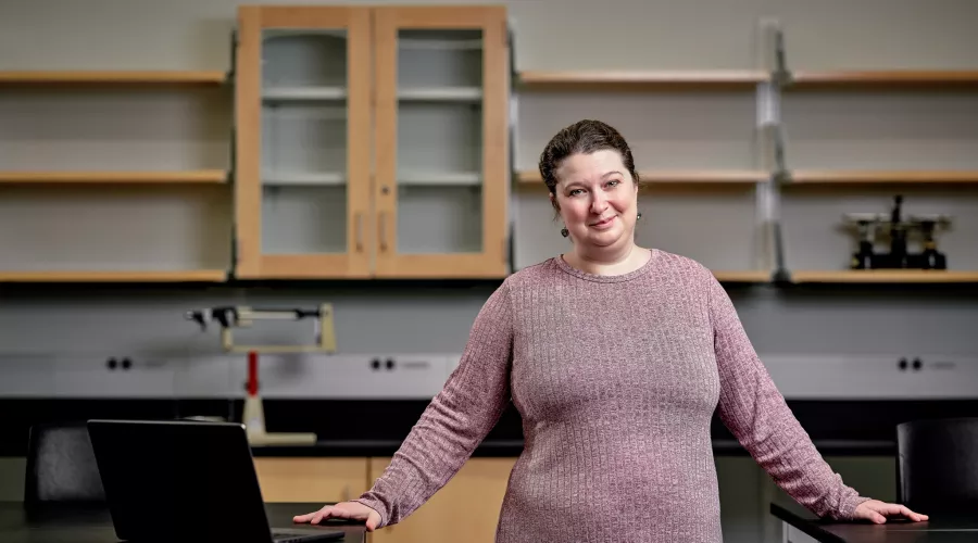 Cheri Levinson with a laptop in a chemistry lab setting